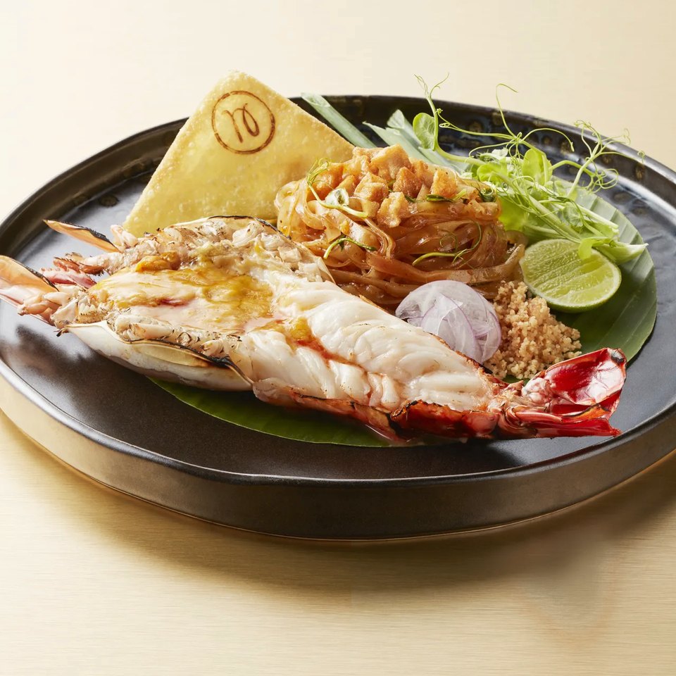 Dry khao soi beside a grilled river prawn